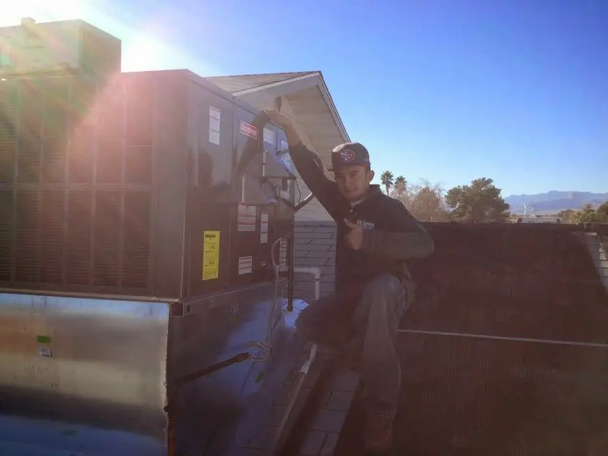 HVAC technician performing Boiler Repair on a rooftop unit in Quakertown